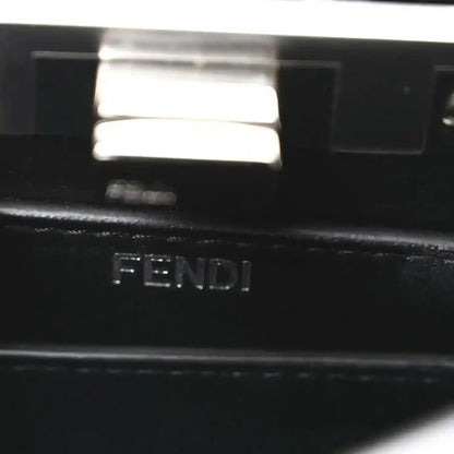Black leather logo stamp reading 'FENDI' on interior panel