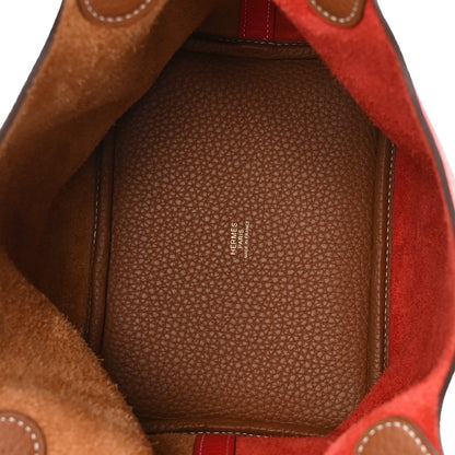 Leather tote interior with textured lining and stitched edge in brown and red