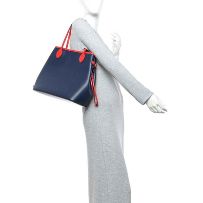 Louis Vuitton Epi Neverfull MM tote bag worn with navy body and red handle accents