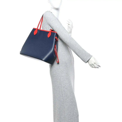 Louis Vuitton Epi Neverfull MM tote bag worn with navy body and red handle accents