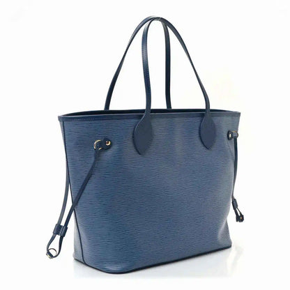Denim blue leather tote bag with side strap, dual top handles, and gold hardware