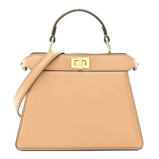Tan leather satchel with top handle, front strap, and gold-tone logo clasp