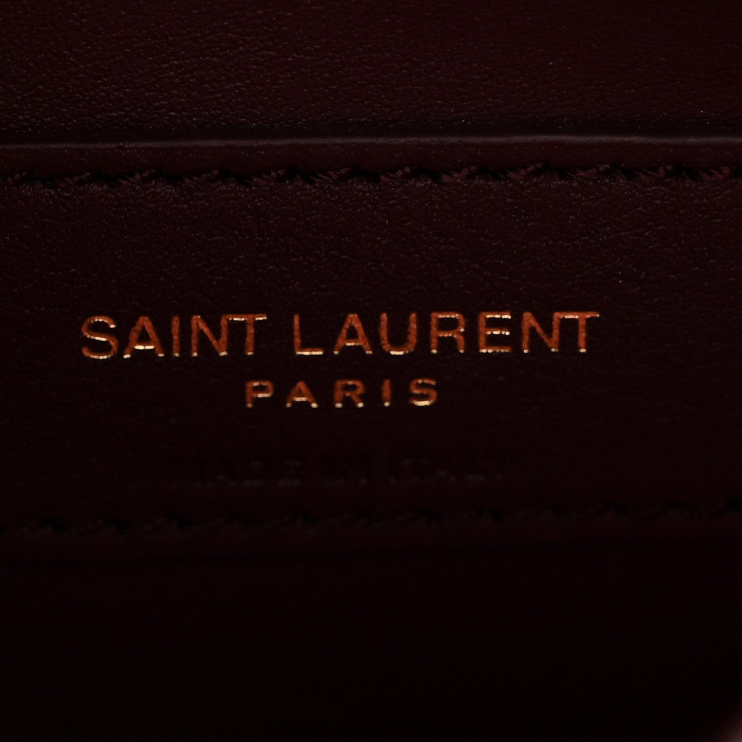 Saint Laurent Paris stamped on burgundy leather lining