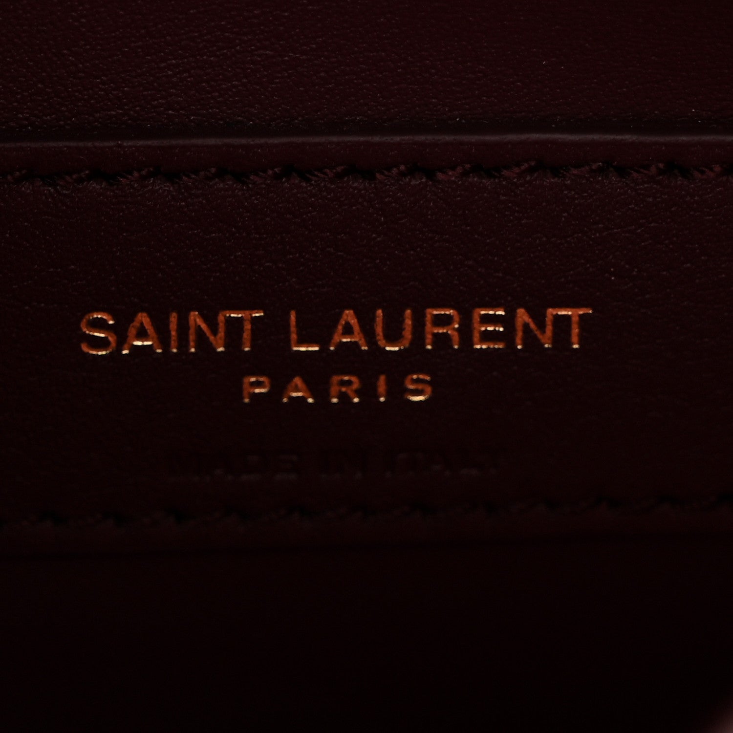 Saint Laurent Paris stamped on burgundy leather lining