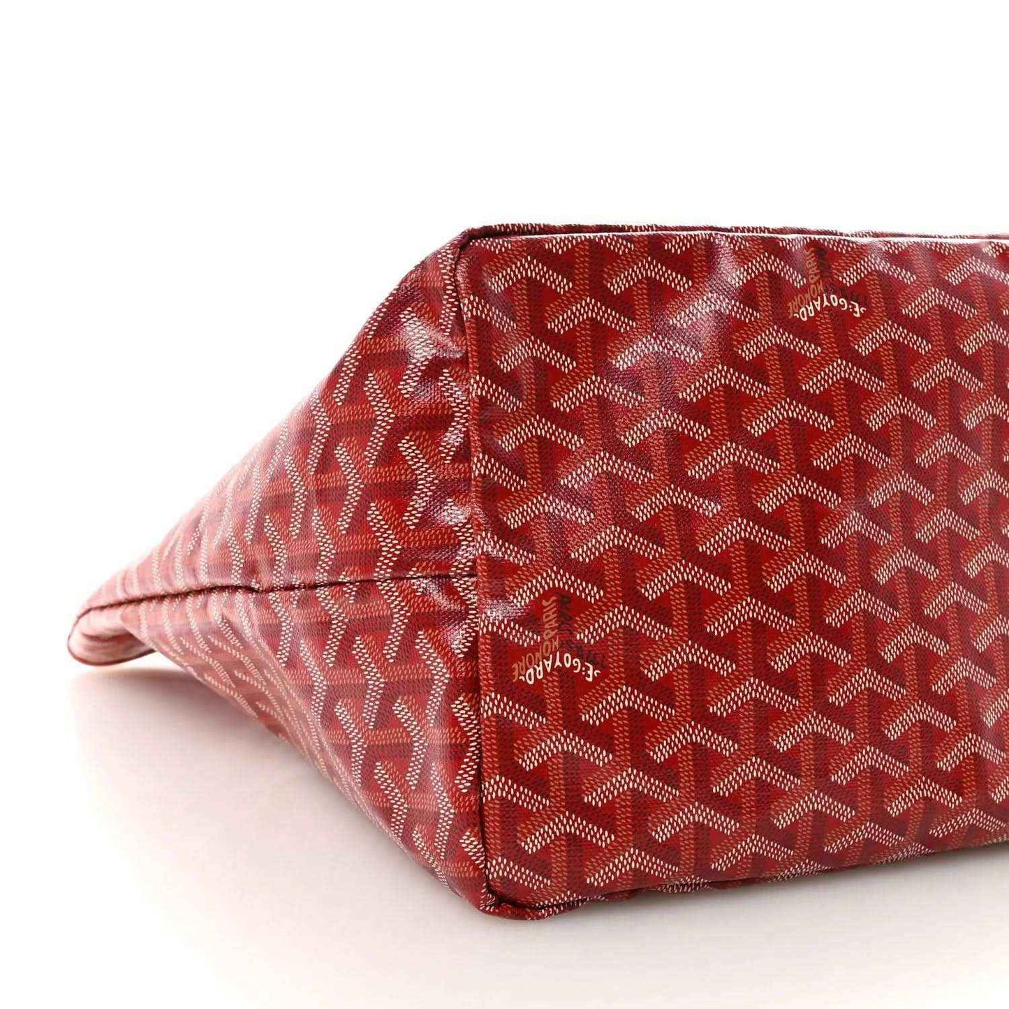 Red Goyardine canvas tote bag bottom corner with Goyard pattern.