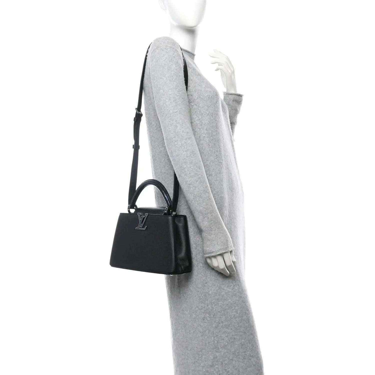 Small black leather handbag with top handle, side view, and short strap