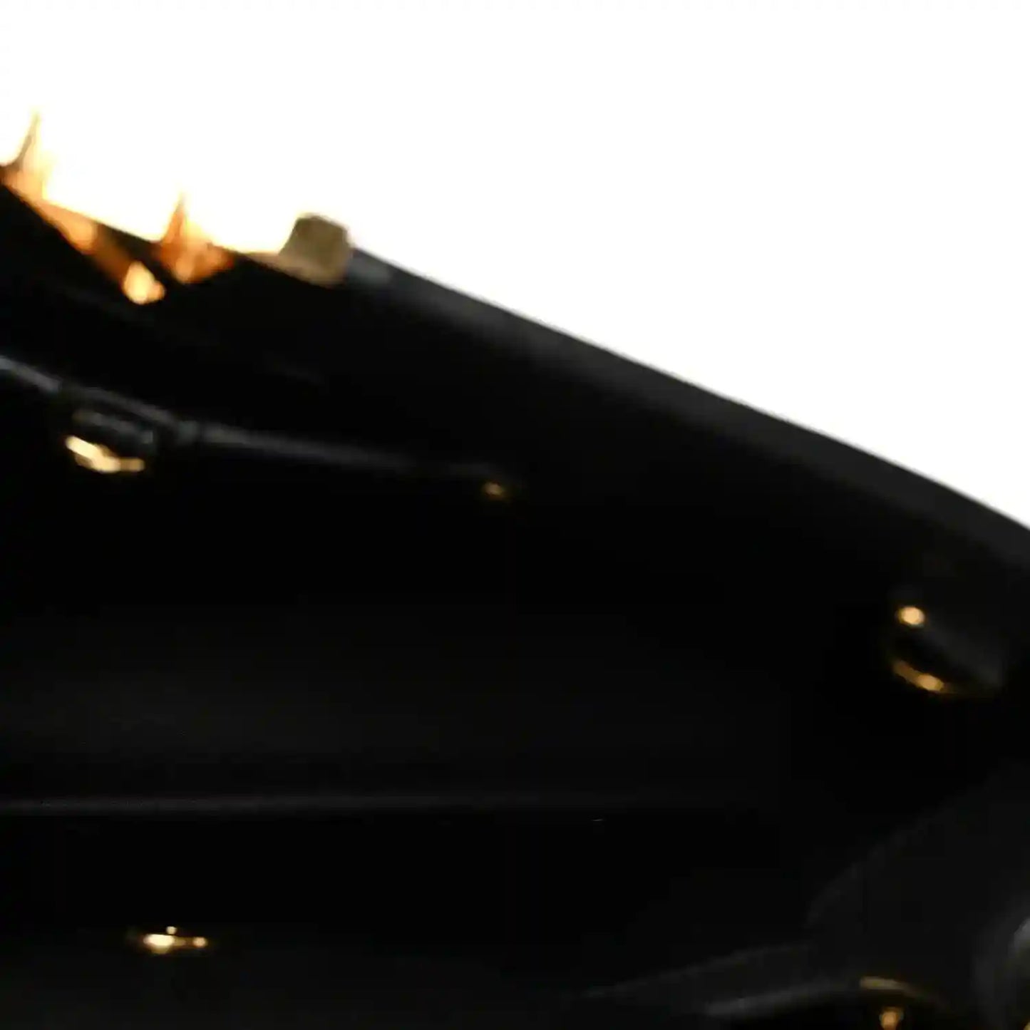 Louis Vuitton Capucines BB bag close-up of black leather edge with gold hardware