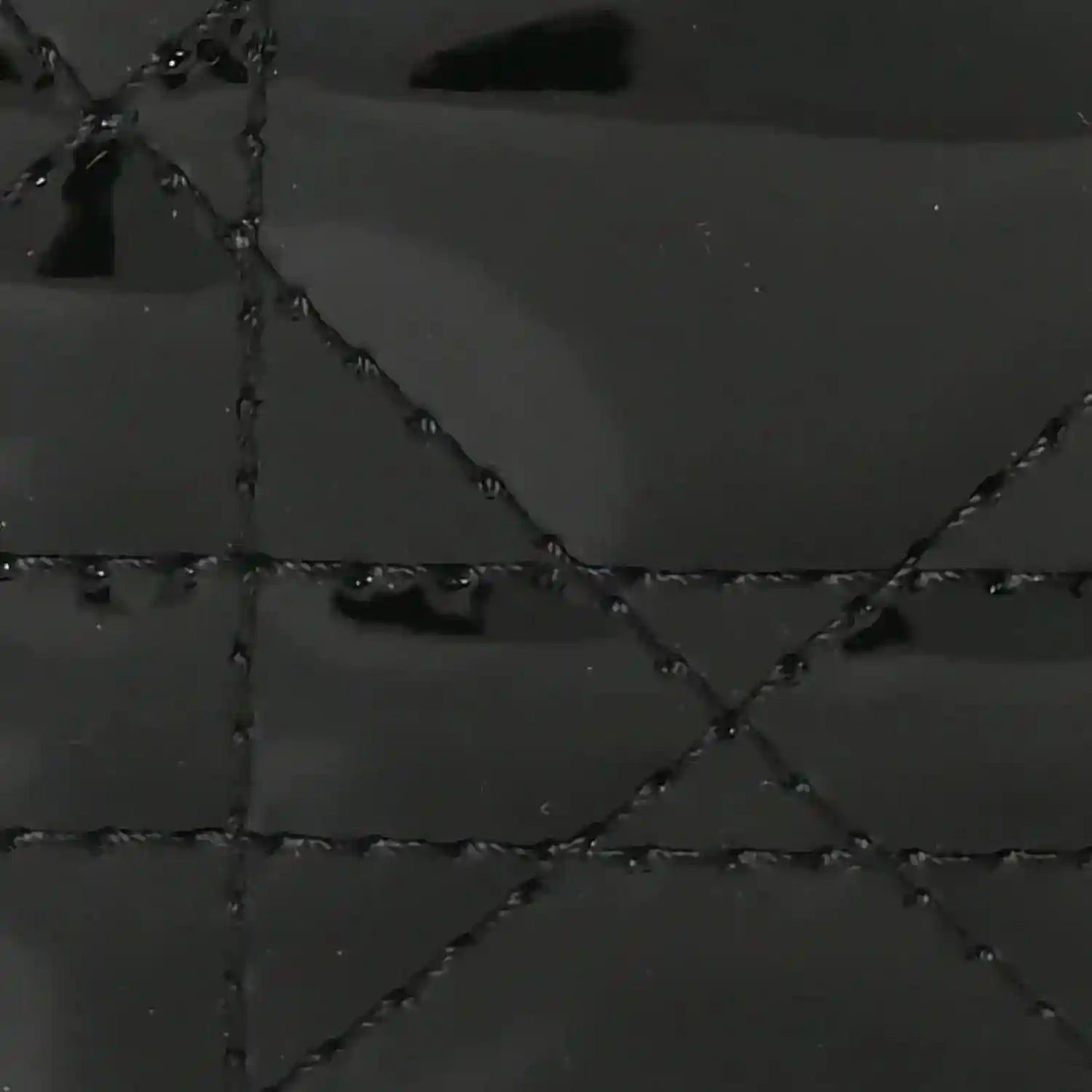 Black patent leather quilted diamond pattern with stitched seams