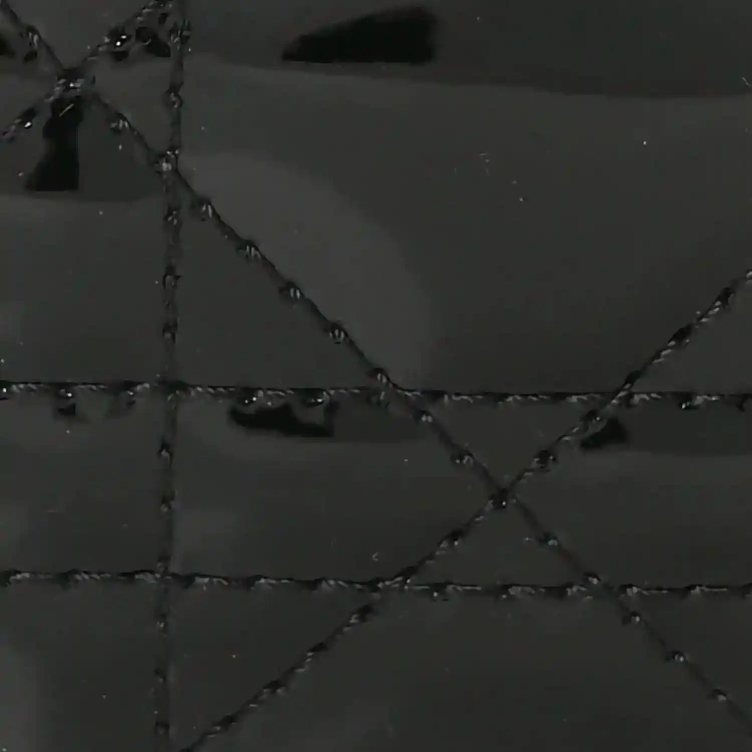 Black patent leather quilted diamond pattern with stitched seams