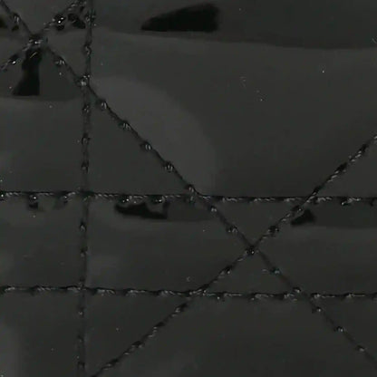 Black patent leather quilted diamond pattern with stitched seams
