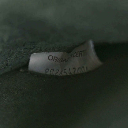 Brand label on dark green leather reading ORIGINAL CERT and number