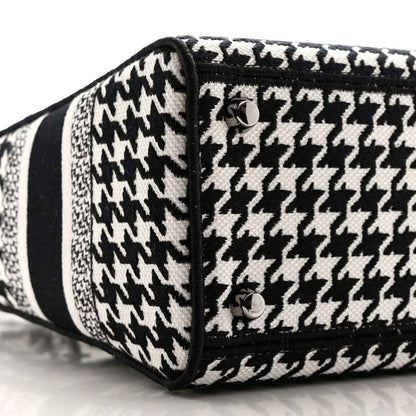 Black-and-white houndstooth canvas bag end with black trim and button detail