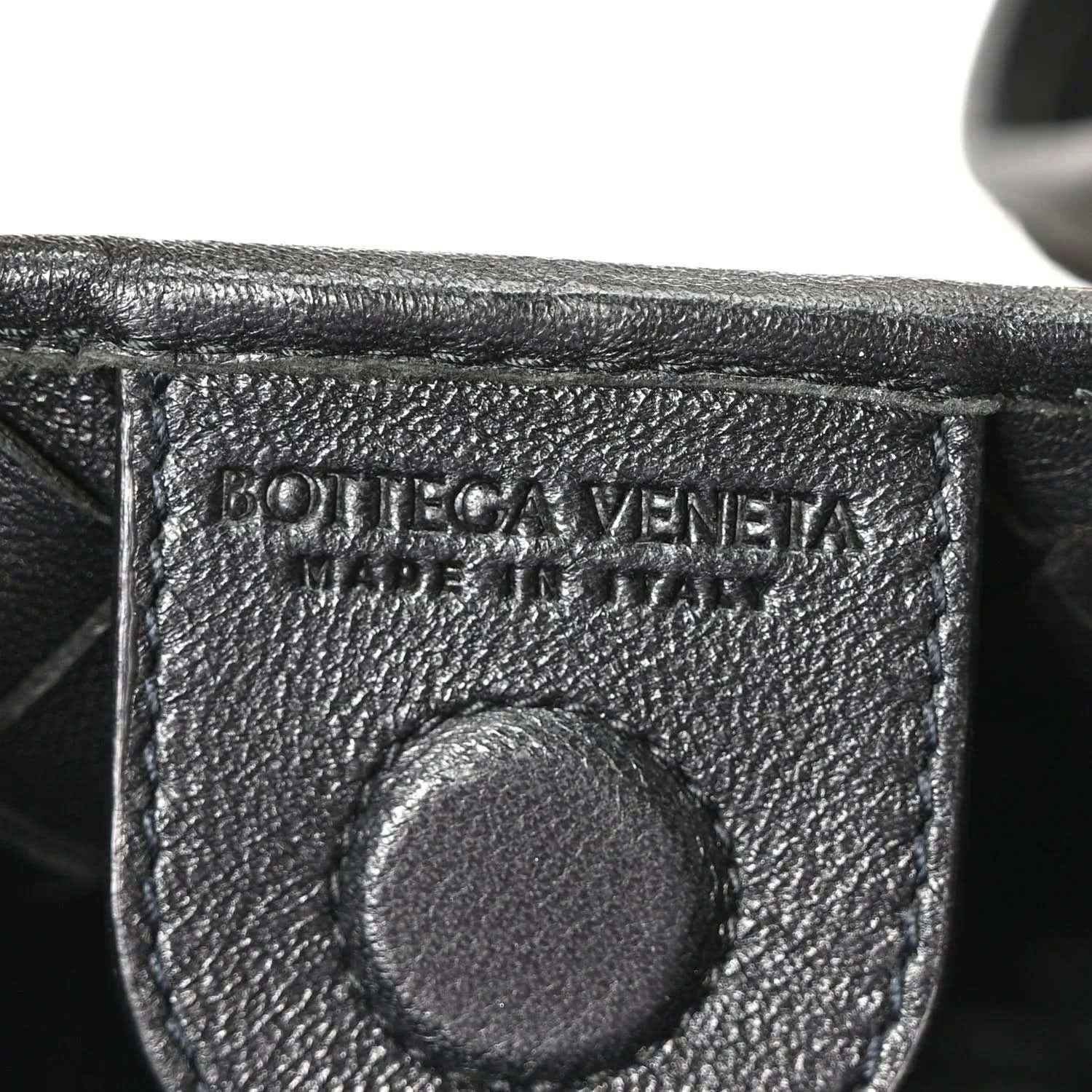 Bottega Veneta leather interior stamp detail on black nappa bag.