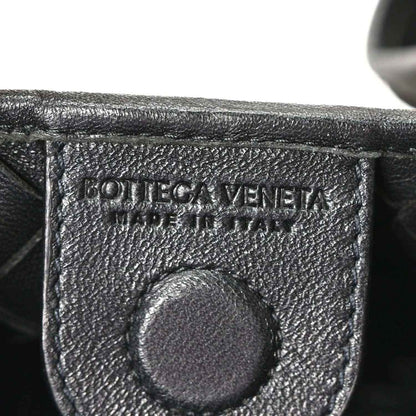 Bottega Veneta leather interior stamp detail on black nappa bag.