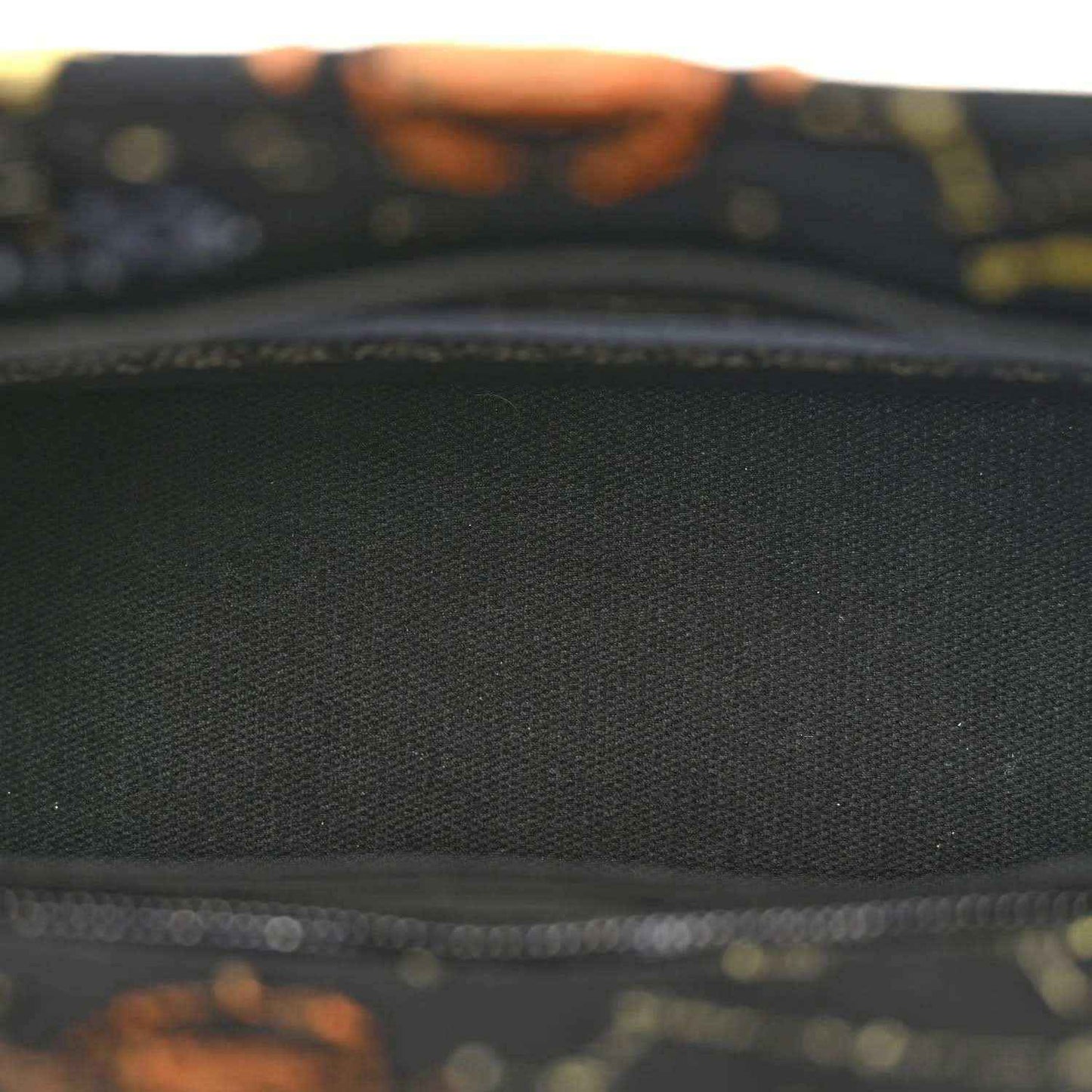 Black fabric bag pocket lining with textured weave and zipper edge detail