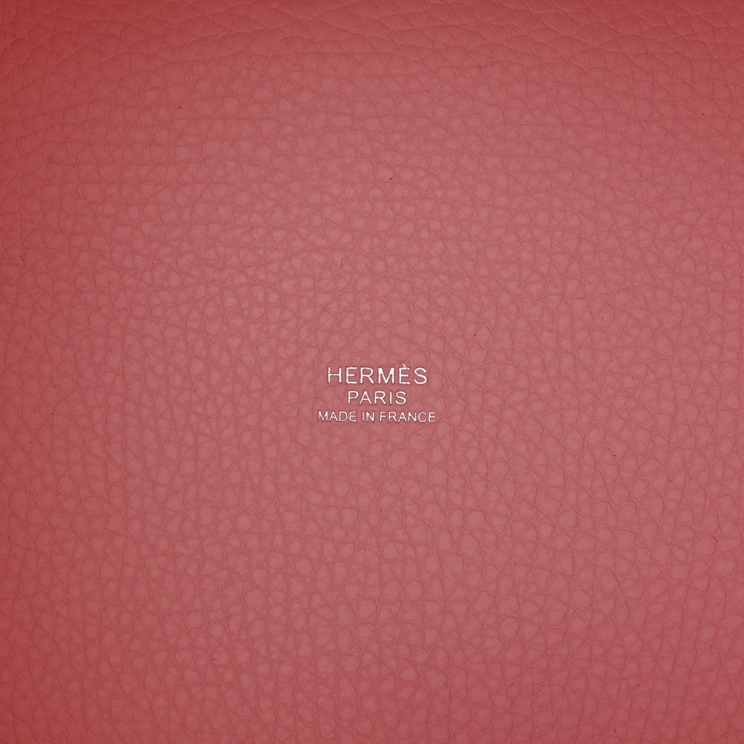 Mauve textured leather handbag interior with stamped brand markings