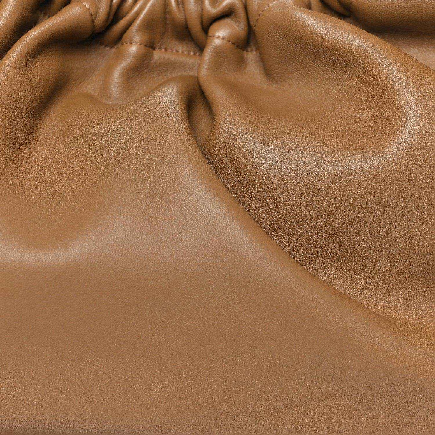 Ruched leather opening of a small shoulder bag, oak brown with gathered texture