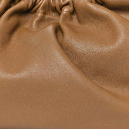 Ruched leather opening of a small shoulder bag, oak brown with gathered texture