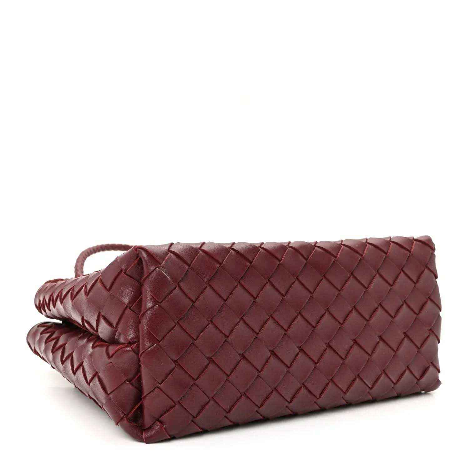 Small burgundy woven nappa leather bag with crossbody strap, side view.