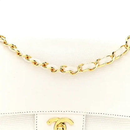 Gold chain strap links and gold turn-lock on white flap