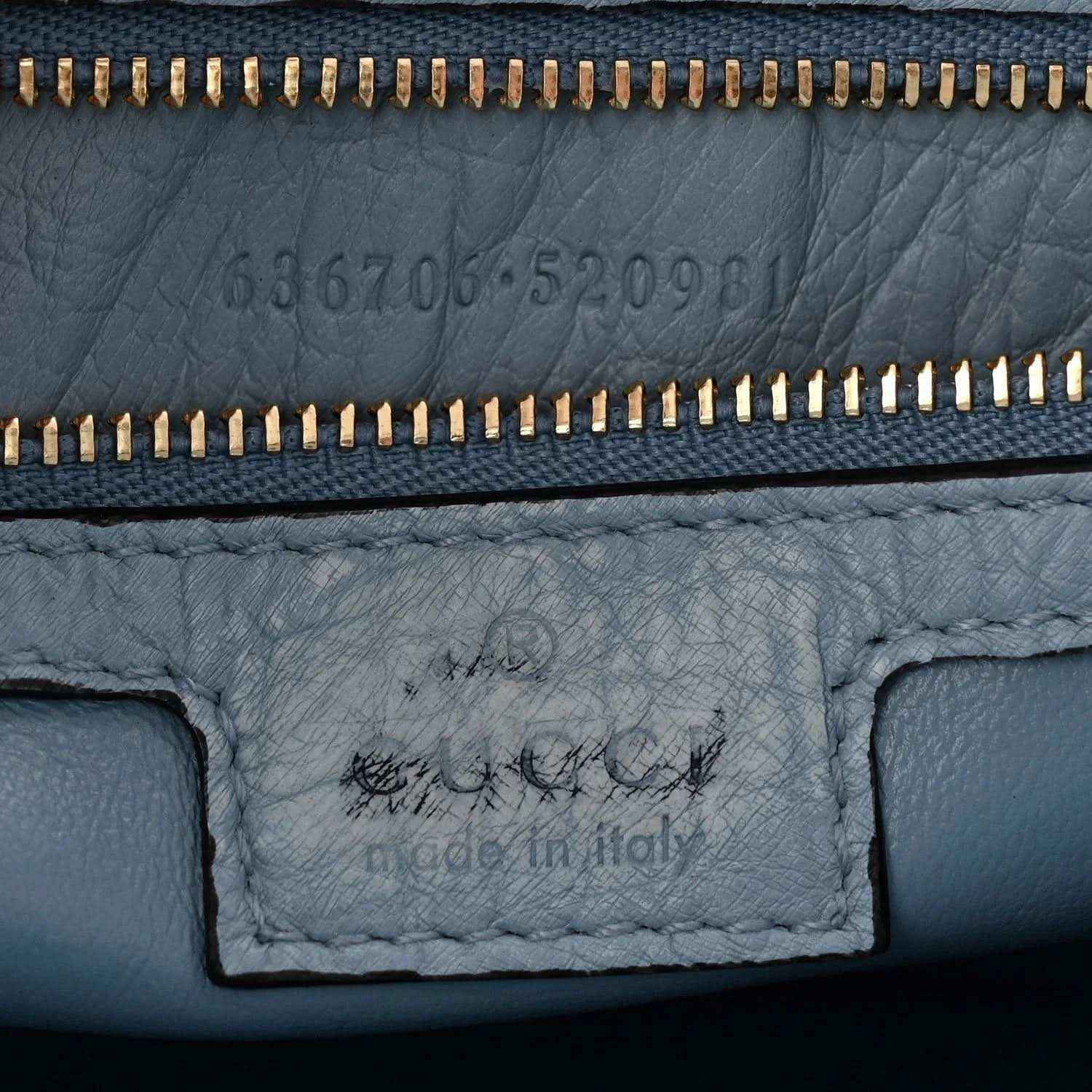 Hobo bag close-up of zipper and stamped leather interior panel