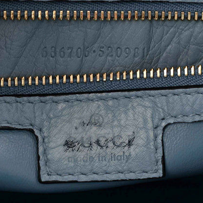 Hobo bag close-up of zipper and stamped leather interior panel