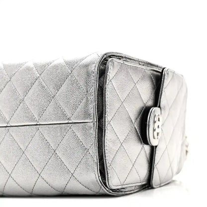 Chanel metallic quilted handbag side with zipper tab and silver chain strap