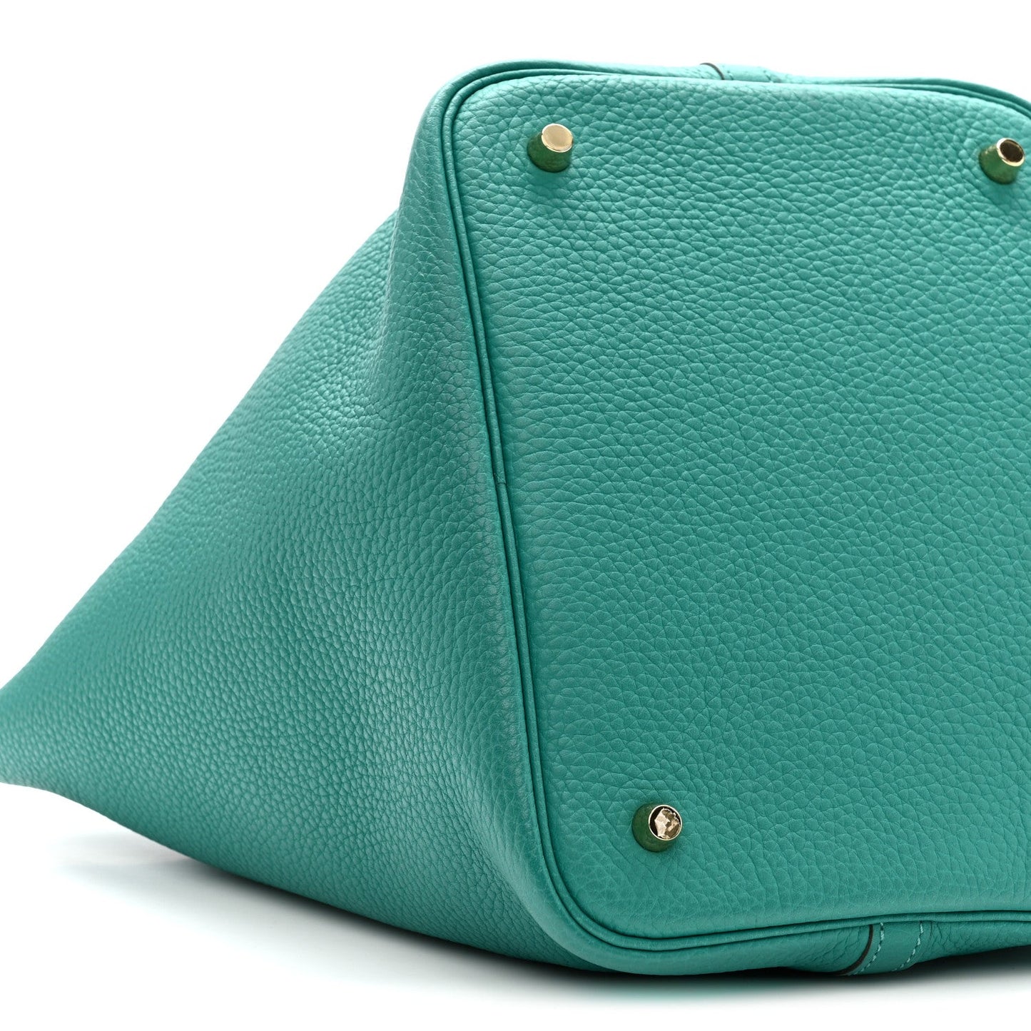 Green leather tote with curved flap, gold-tone studs, and top handle