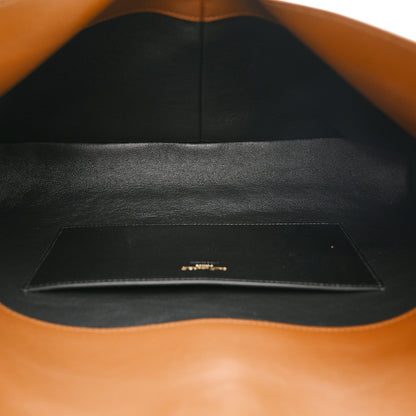 Caramel suede pouch on chain bag with black fabric interior and stitched pocket