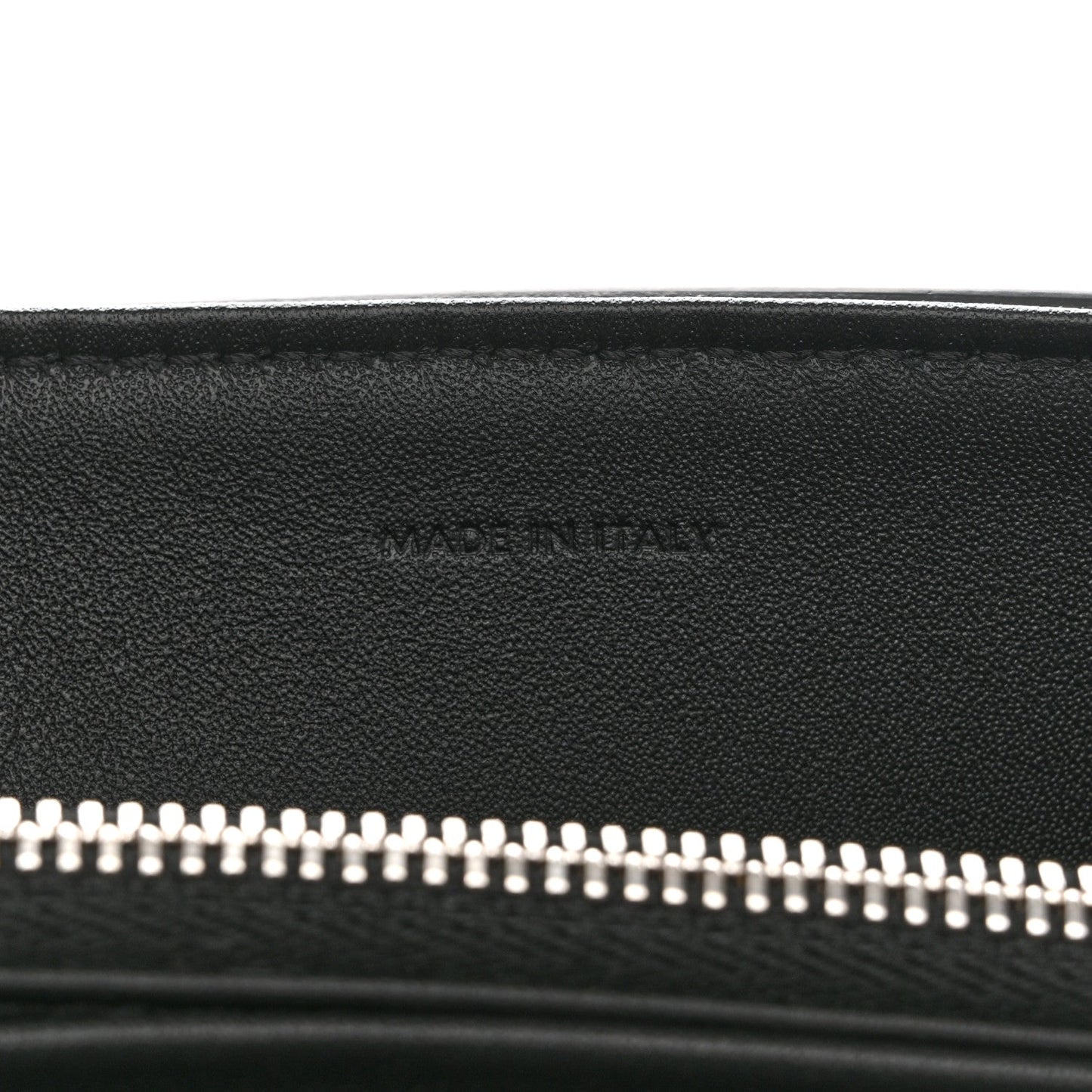 Black leather bag with silver zipper teeth along the top opening
