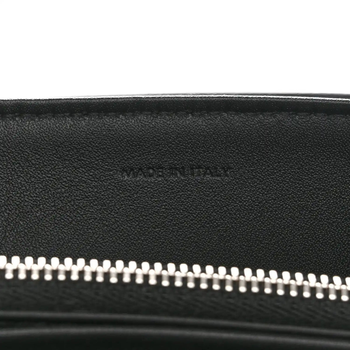 Black leather bag with silver zipper teeth along the top opening