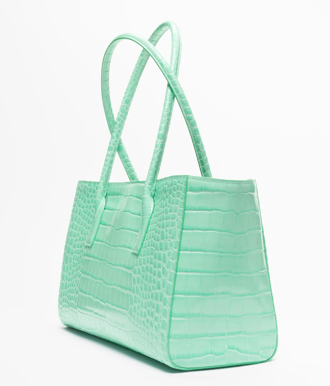 Teal croc-embossed leather tote bag with wide handles and structured rectangular shape
