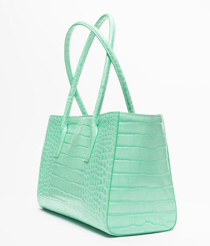 Teal croc-embossed leather tote bag with wide handles and structured rectangular shape