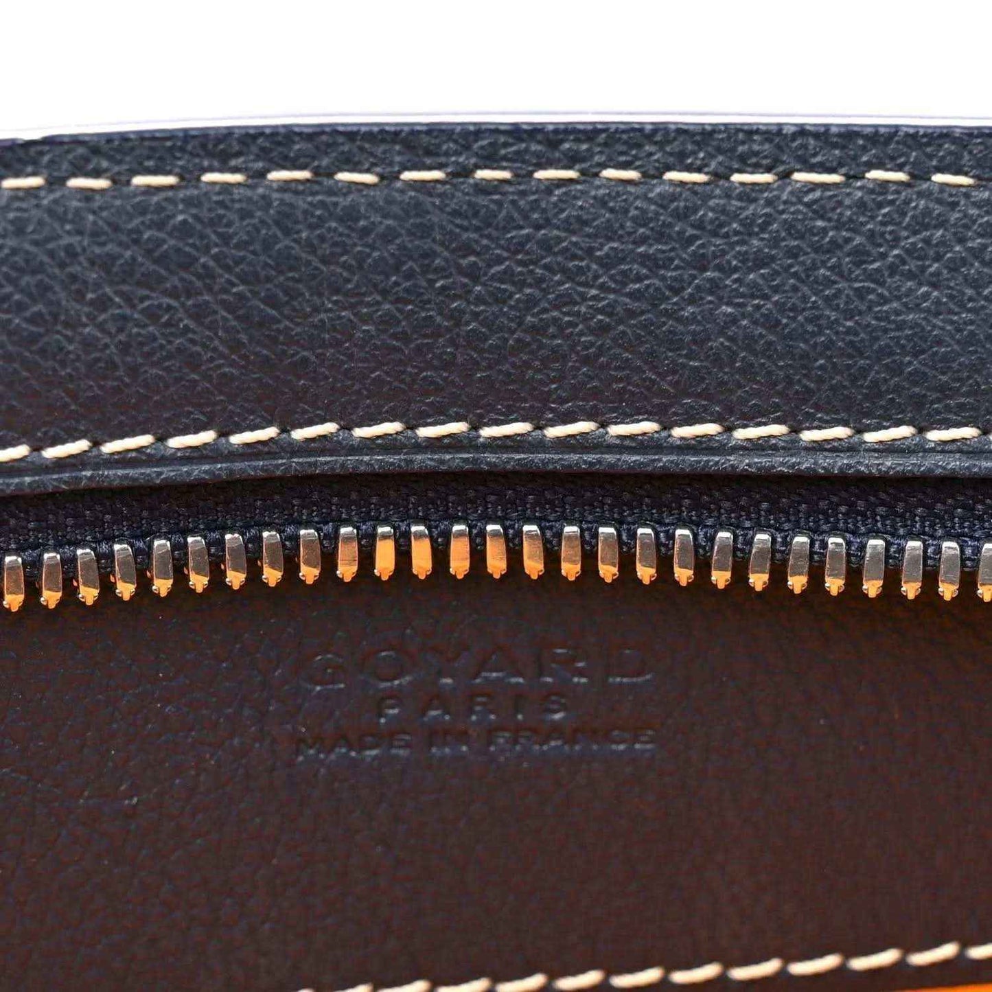 Dark navy leather edge with zipper teeth and contrast white topstitching