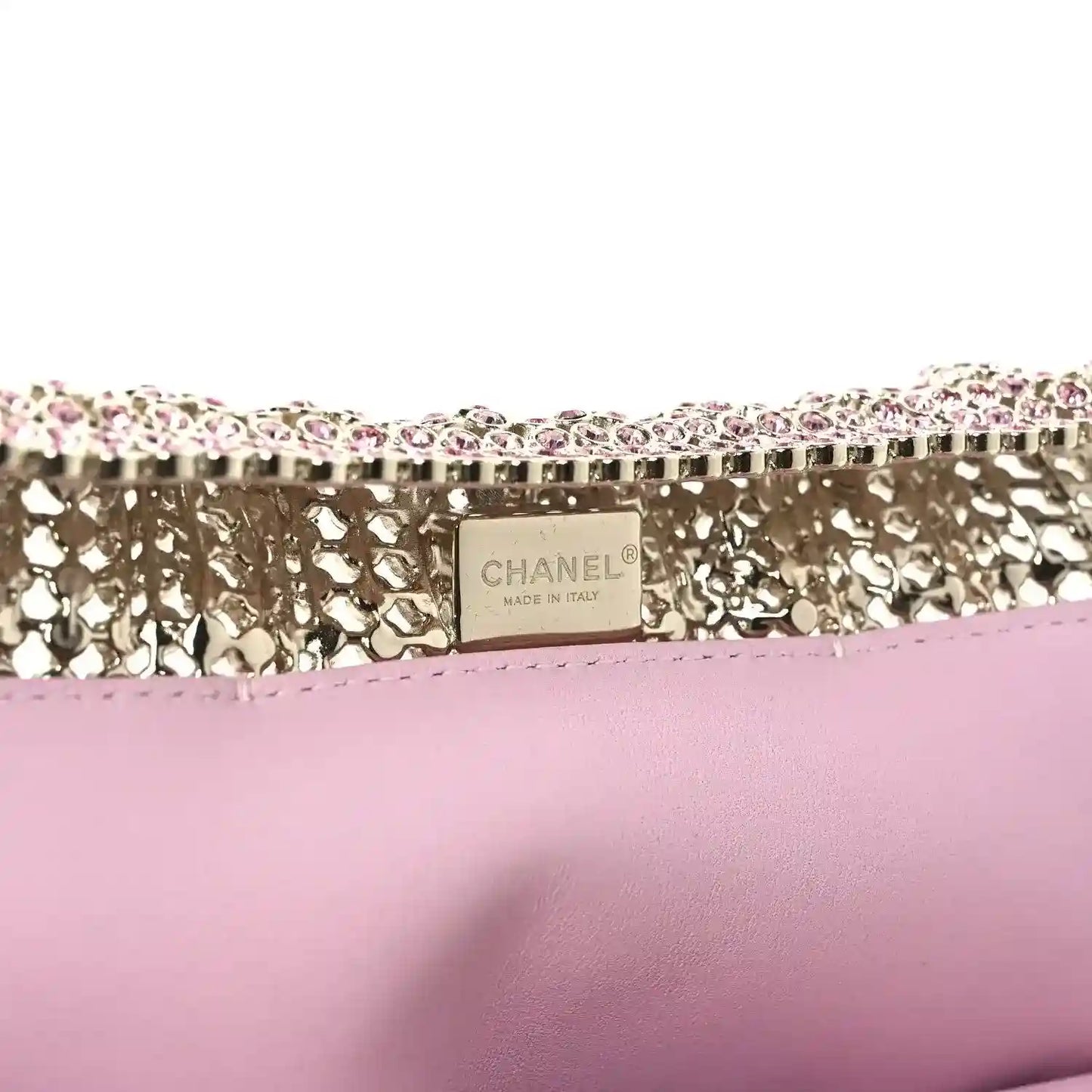 Chanel Mini 22 handbag back panel with Chanel label on pink leather base and crystal trim.