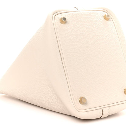 Pale cream textured leather tote bottom with corner rivets and stitched borders