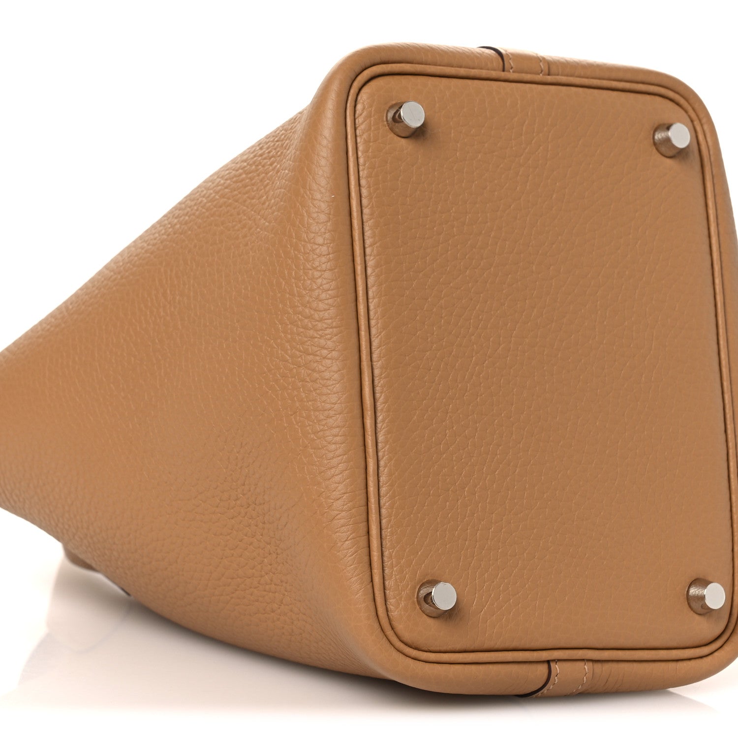 Tan textured leather bucket bag with silver lock hardware and top loop handle.