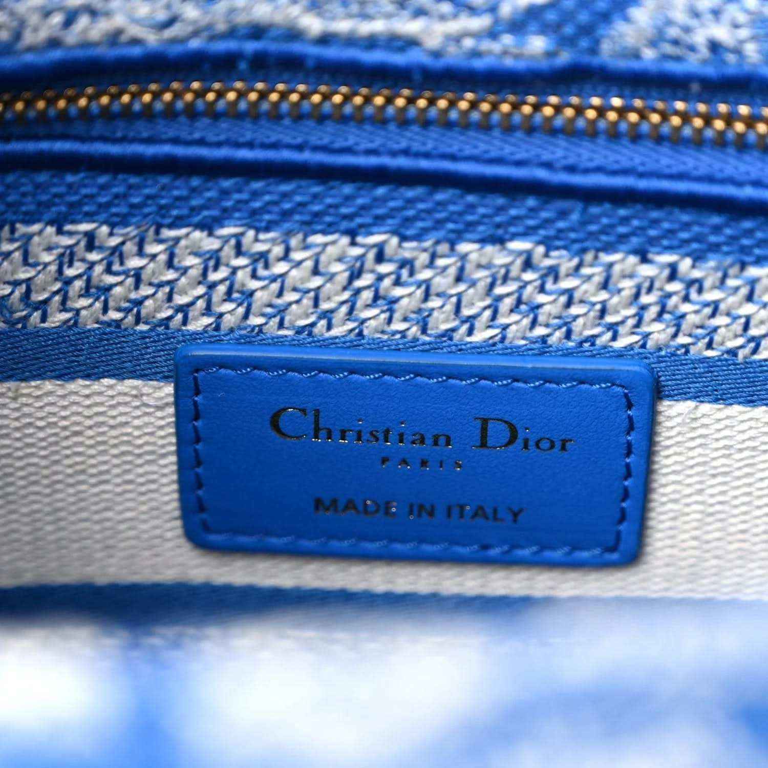 Blue leather brand label reading Christian Dior and Made in Italy on handbag