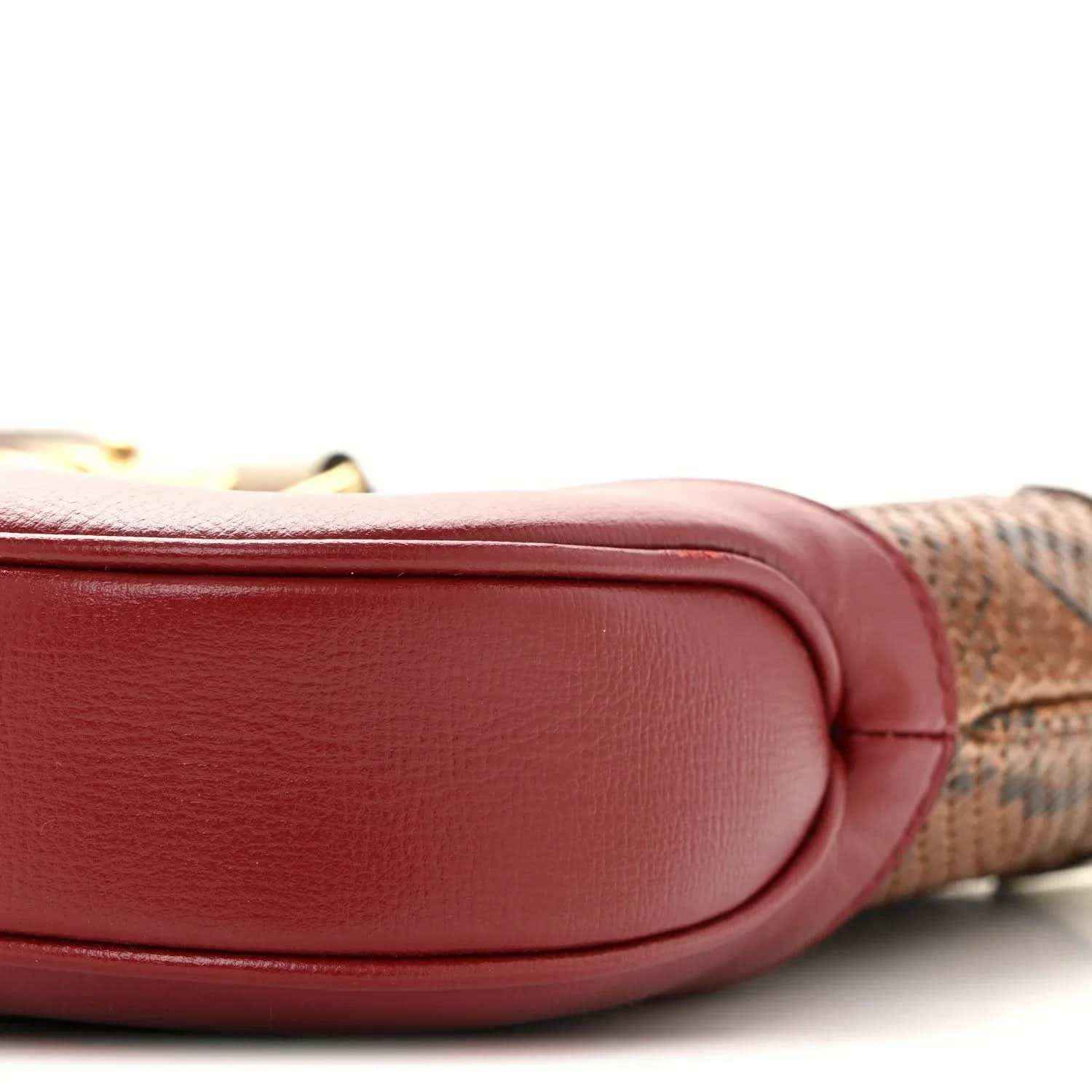 Hobo bag corner with smooth pink leather, stitched edge, and snakeskin trim.