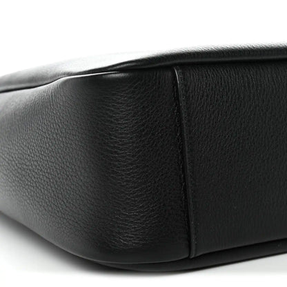 Black calfskin hobo bag side panel with structured seam and rounded bottom edge.
