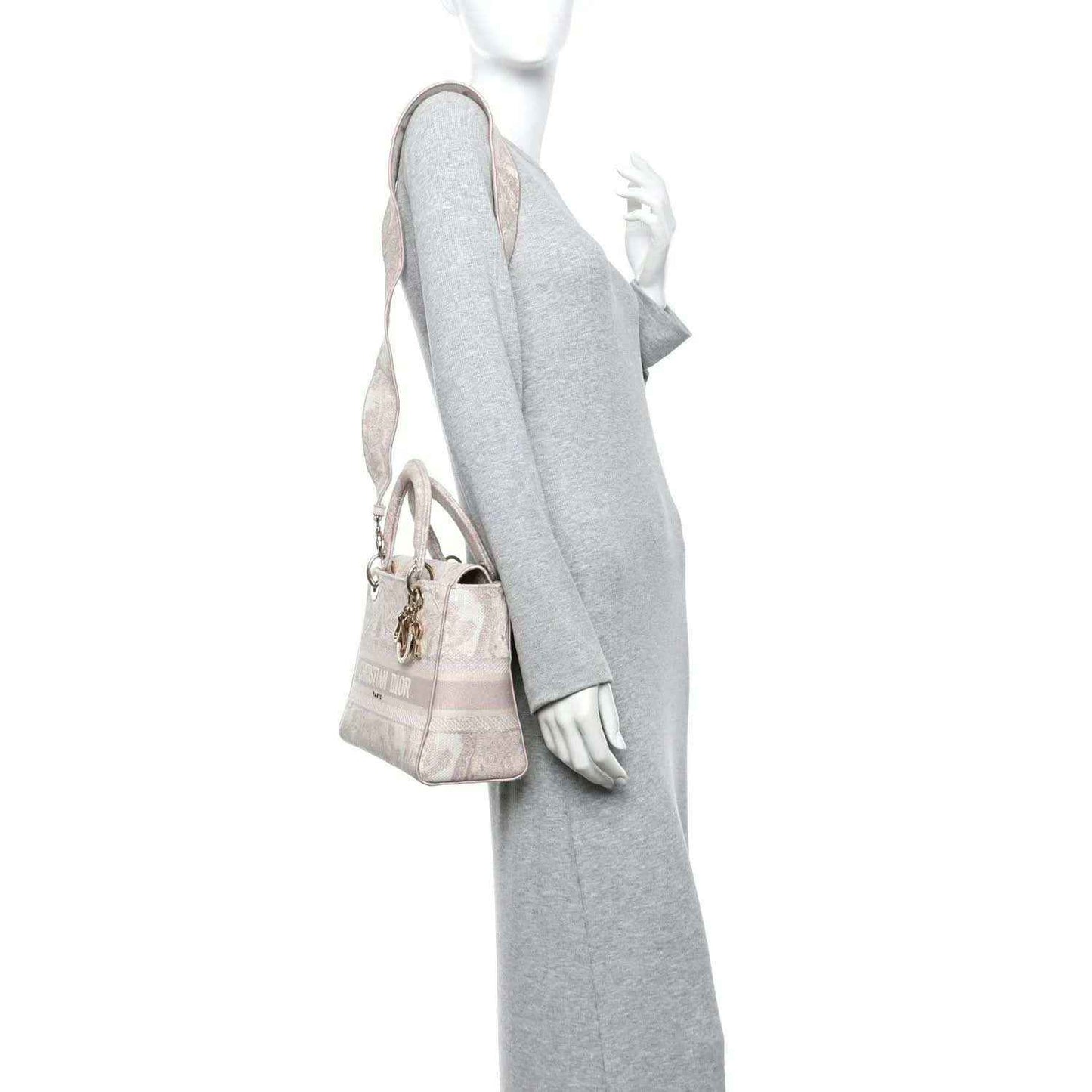 Medium rose-pink embroidered handbag with top handles, gold hardware, and charm detail