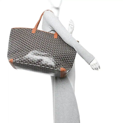 Goyard Artois GM tote bag shown on mannequin, black Goyardine canvas and tan trim