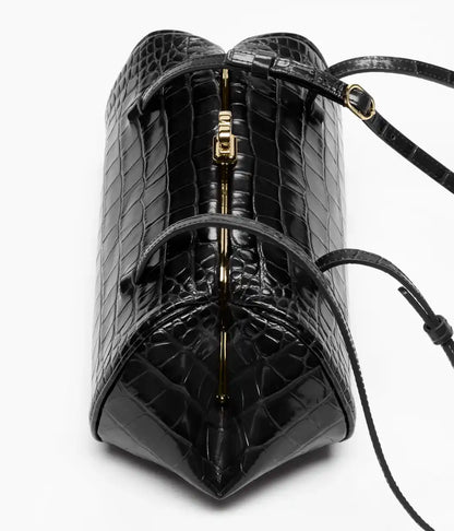 Black croc-embossed leather clutch with top handle strap and gold clasp