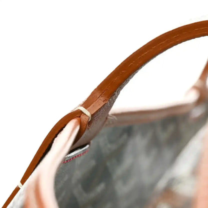 Black Goyardine canvas tote bag with brown leather top handle and tied cord