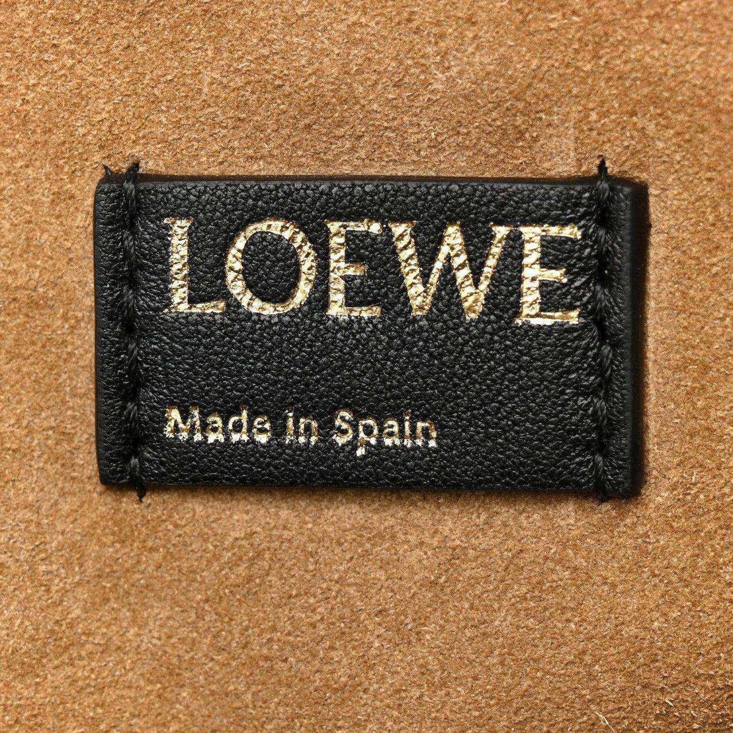 Black leather Loewe tag with LOEWE lettering and Made in Spain