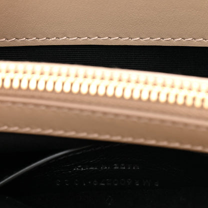 Suede bag zipper opening with gold zipper teeth and black lining