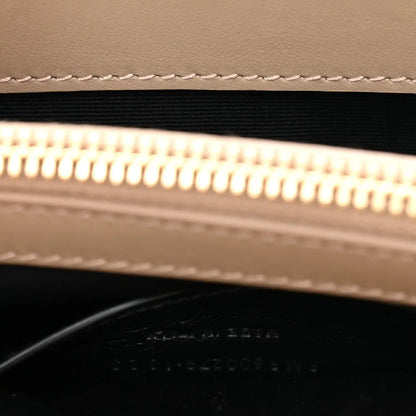 Suede bag zipper opening with gold zipper teeth and black lining