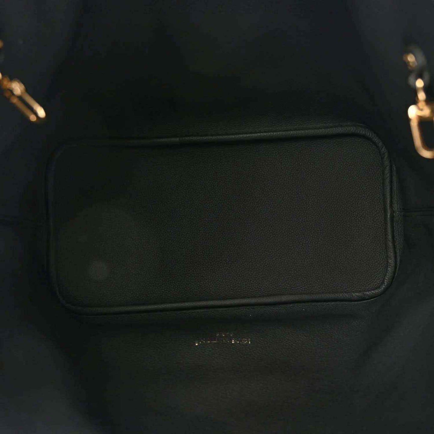 Black-lined tote interior pocket with leather trim and gold-toned hardware