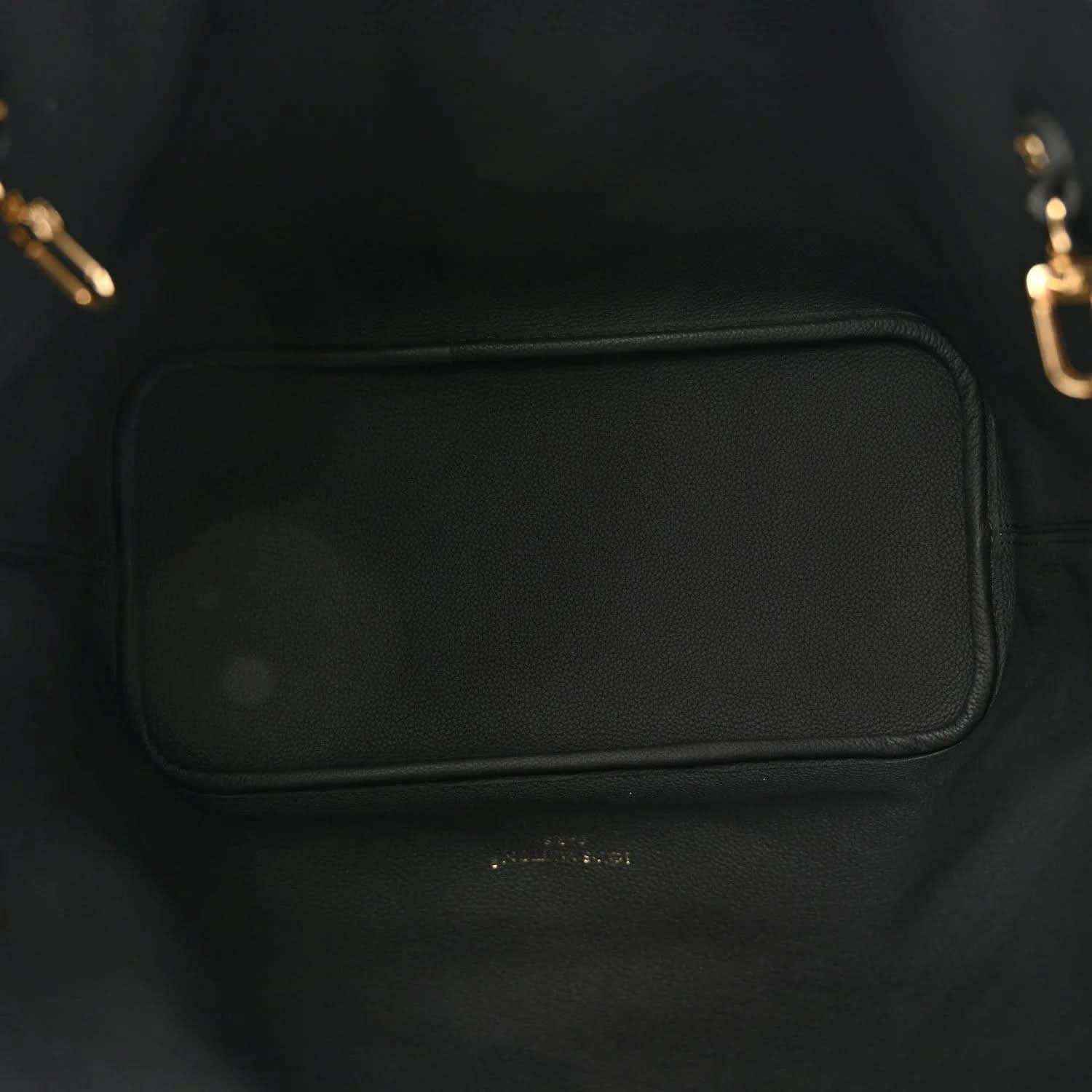 Black-lined tote interior pocket with leather trim and gold-toned hardware