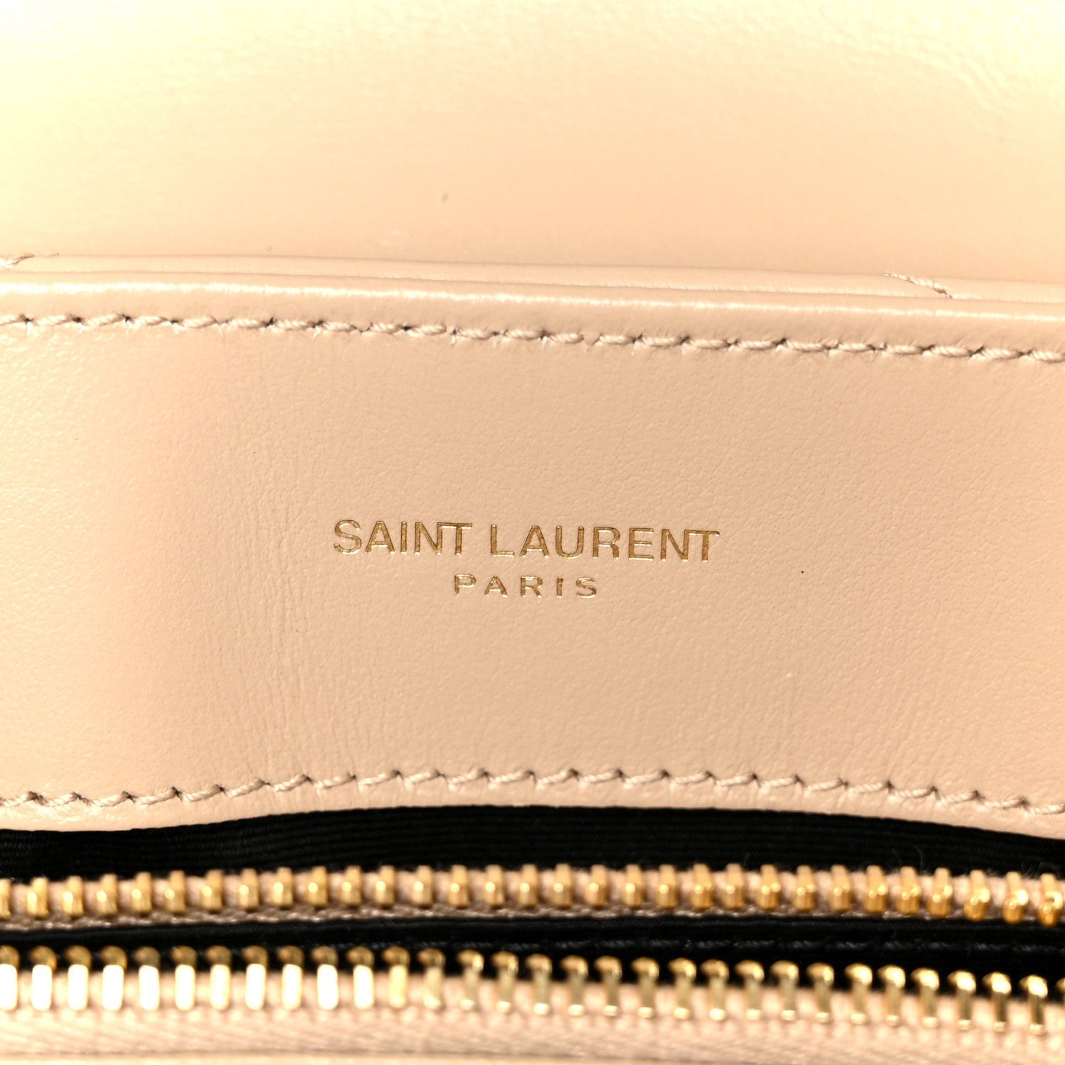 Dark beige leather satchel detail with stitched Saint Laurent Paris logo patch